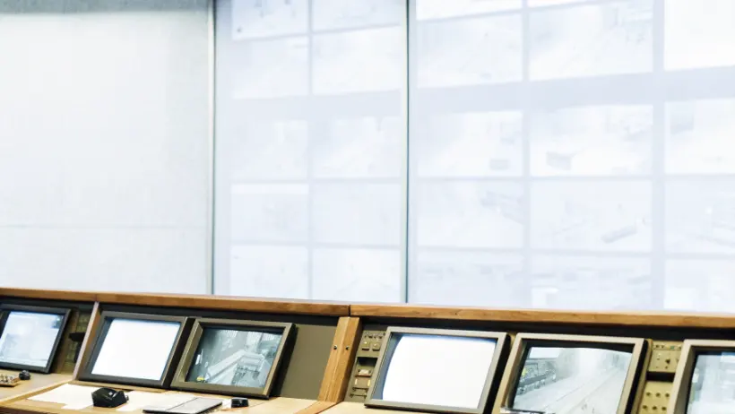 Casino security control room with multiple monitors showing gaming floor surveillance camera feeds
